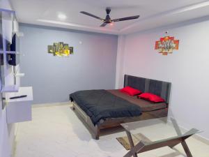 a bedroom with a bed and a ceiling fan at Hotel Paradise in Rewa
