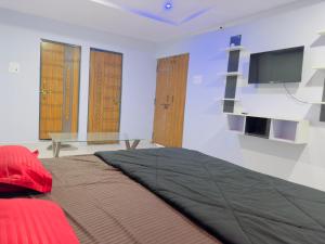 a room with a bed with a flat screen tv at Hotel Paradise in Rewa