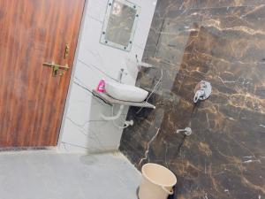 a bathroom with a sink and a toilet at Hotel Paradise in Rewa