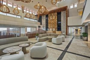 a lobby with couches and tables in a building at Grand Fiesta Americana Veracruz in Veracruz