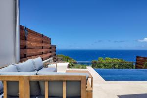 a view of the ocean from the patio of a villa at Luxury Oceanfront Villa Heated Infinity Pool in Petite Île