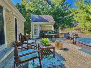 a patio with benches and a table on a deck at Cape Cod Retreat, Osterville Beach Pass in Osterville