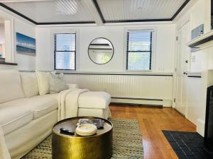 a living room with a white couch and a table at Cape Cod Retreat, Osterville Beach Pass in Osterville