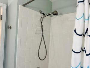 a shower with a shower head in a bathroom at Cape Cod Retreat, Osterville Beach Pass in Osterville +19 photos
