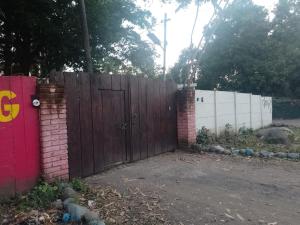 a fence with a wooden gate and a brick wall at EL sunzal Bliss #8 in El Sunzal