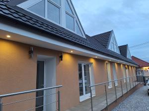 a house with a metal roof and a balcony at Vila Rosa in Spišský Štvrtok
