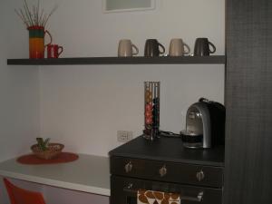 a kitchen with a counter with a coffee maker on a dresser at Casa Bella in Argegno