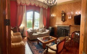 a living room with a couch and a fireplace at Hotel Cordillera in Talca