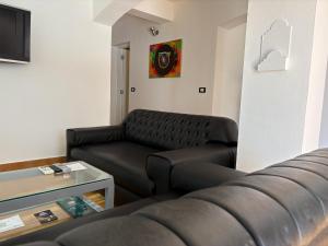 a living room with a couch and a table at Sanafir Hotel - El Pacha Suites Sharm - Adults Only in Sharm El Sheikh