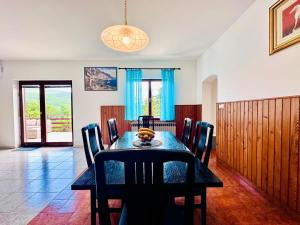 a dining room with a table and chairs at Kuća Sonja in Vranje