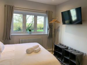 a bedroom with a bed and a tv on the wall at Park View Guest Suite in South Milford