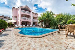 a villa with a swimming pool and a house at Villa Beganović in Krk
