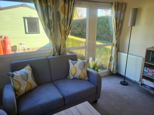 a living room with a couch and a large window at Nidd Way Holiday Let in Knaresborough +52 photos