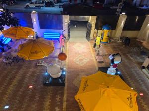 an overhead view of two yellow umbrellas in a room at El Mandara Residence Inn in Alexandria
