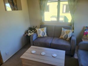 a living room with a couch and a coffee table at Nidd Way Holiday Let in Knaresborough