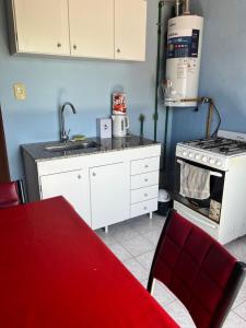 a kitchen with a sink and a stove at Rincón Bosc in Ramallo