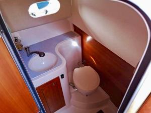 a small bathroom with a sink and a toilet at Palermo Boat Experience in Isola delle Femmine +8 photos