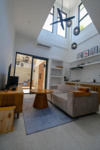 a living room with a couch and a table at Virgo Sun House in Uluwatu