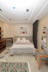 a bedroom with a large bed and a chair at El Mandara Residence Inn in Alexandria +122 photos