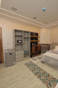 a bedroom with a bed and a dresser at El Mandara Residence Inn in Alexandria