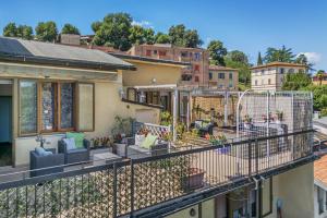a balcony with a view of a house at Casamia Tuscan Oasis 4Br Panoramic Penthouse Hot Tub & Easy Parking in Siena
