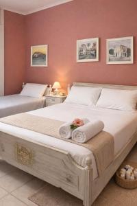 a bedroom with a large bed with towels on it at Art Suites Mesologgi in Missolonghi