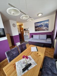 a living room with a table and a couch at Pension Sonnenheim inkl ZomerKärntenCard in Gmünd in Kärnten