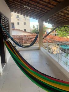 a hammock in a room with a building at Pousada e Hostel Praia do poço in Cabedelo