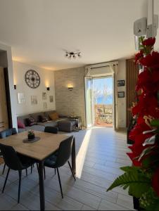 a living room with a table and a couch at OdeMar Apartment in Pozzuoli