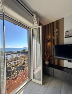 a living room with a sliding glass door to a balcony at OdeMar Apartment in Pozzuoli