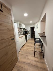 a kitchen with a door and a chair in a room at Charmant appartement Chaleureux in Hyères +9 photos
