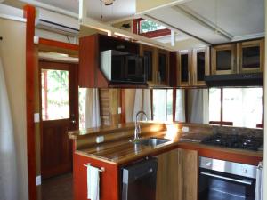 a kitchen with a sink and a microwave at Casa Hermosa FAM Little House in Santa María +9 photos