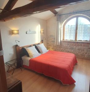 a bedroom with a large bed with a red blanket at Chambres d'Hôtes Grange Carrée in Saint-Rémy +26 photos