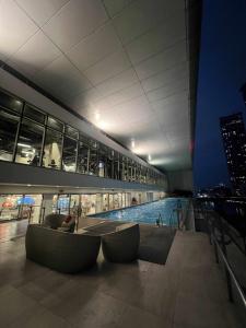 a building with a swimming pool on top of it at Novotel at Acqua, The Hotel Residences by RM in Manila