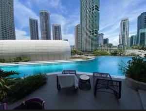a swimming pool in a city with tall buildings at Novotel at Acqua, The Hotel Residences by RM in Manila