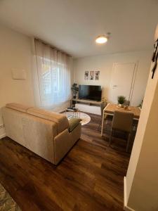 a living room with a couch and a table at Satori House in Sanremo