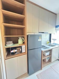 a kitchen with a refrigerator and a sink at The Cust Phuket in Ban Khok Chang +11 photos