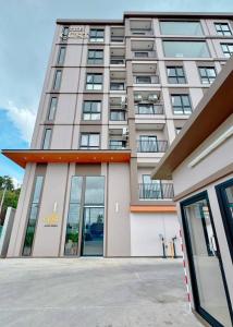 a large building with glass doors in front of it at The Cust Phuket in Ban Khok Chang