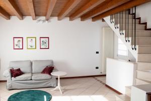 a living room with a couch and a staircase at A casa di Giò in Vittorio Veneto +9 photos