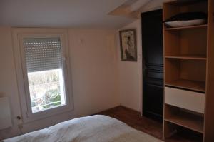 a bedroom with a bed and a window at CEZANNe in Peynier