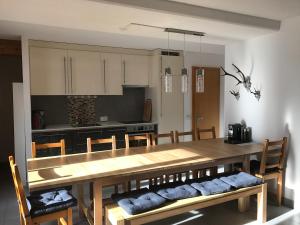 a kitchen with a large wooden table and chairs at Chalet Ski in&out in Les Collons