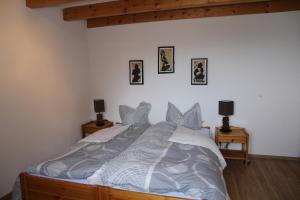 a large bed in a bedroom with two night stands at Chalet Ski in&out in Les Collons