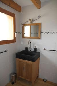 a bathroom with a sink and a mirror at Chalet Ski in&out in Les Collons +18 photos