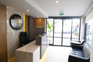 a lobby with a waiting room with a couch and chairs at Nas Corner Hotel in Antalya