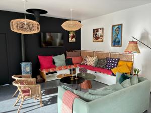 a living room with a couch and a table at 6-person villa with pool in Locquirec