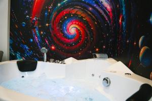 a bathroom with a painting of a bath tub at Espace-Jacuzzi-Cinema-Nintendo switch in Roubaix
