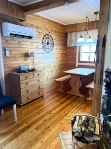 a room with wooden walls and a desk and a window at Susitupa 5 in Salla +44 photos