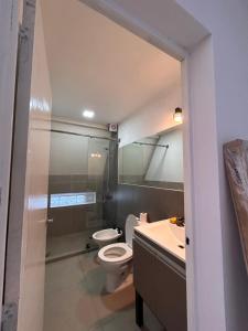 a bathroom with a toilet and a sink at Selah Cabaña de dos habitaciones in Villa Las Rosas +18 photos