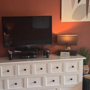 a large white dresser with a flat screen tv on it at Green Hill Guest Room Overijse in Overijse