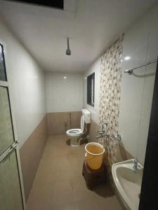 a bathroom with a toilet and a sink at Mist Leaf Villa Mahabaleshwar in Mahabaleshwar